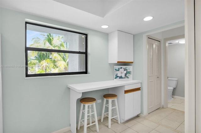 601 W Ocean Dr Dr Unit 411C, Key Colony, FL 33051 - kitchen with white cabinetry, a kitchen breakfast bar, light countertops, baseboards, and recessed lighting