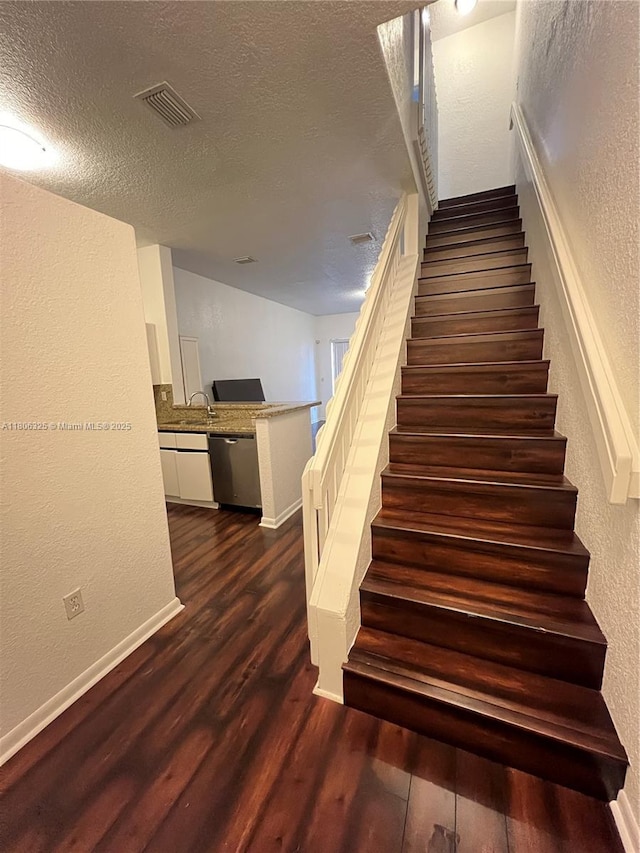 20820 San Simeon Way Unit 24-G, Miami, FL 33179 - stairs featuring a textured wall, wood finished floors, a textured ceiling, and baseboards