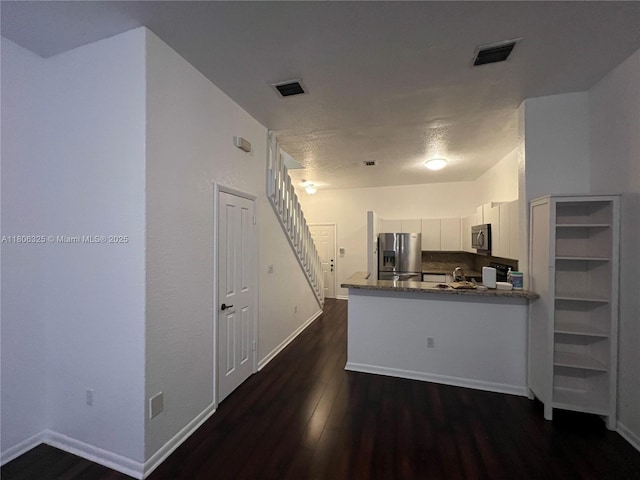 20820 San Simeon Way Unit 24-G, Miami, FL 33179 - kitchen with appliances with stainless steel finishes, dark wood finished floors, baseboards, and white cabinets
