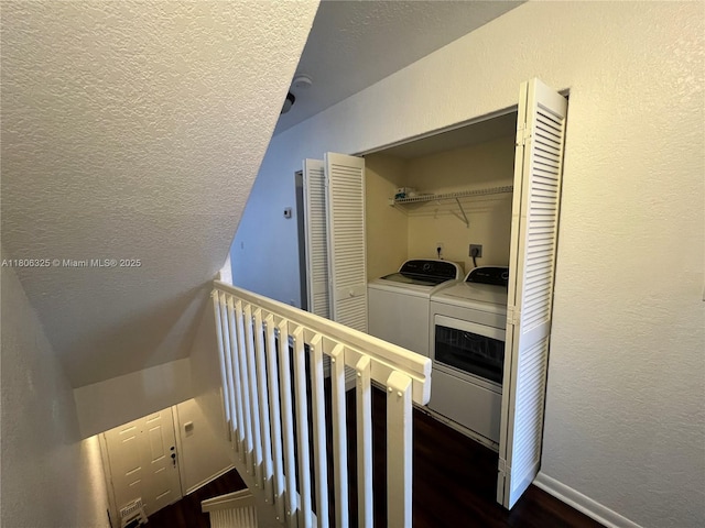 20820 San Simeon Way Unit 24-G, Miami, FL 33179 - stairs featuring wood finished floors, a textured wall, washer and clothes dryer, a textured ceiling, and baseboards