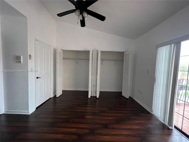 20820 San Simeon Way Unit 24-G, Miami, FL 33179 - unfurnished bedroom with vaulted ceiling, dark wood-style flooring, two closets, baseboards, and ceiling fan