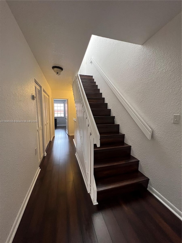 20820 San Simeon Way Unit 24-G, Miami, FL 33179 - staircase with hardwood / wood-style floors, a textured wall, and baseboards