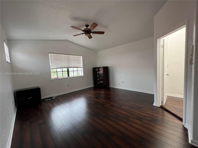 20820 San Simeon Way Unit 24-G, Miami, FL 33179 - empty room with a ceiling fan, dark wood-type flooring, lofted ceiling, and baseboards