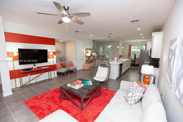 1515 Carey Palm Cir, Kissimmee, FL 34747 - living room with ceiling fan, dark tile patterned flooring, a textured ceiling, and recessed lighting
