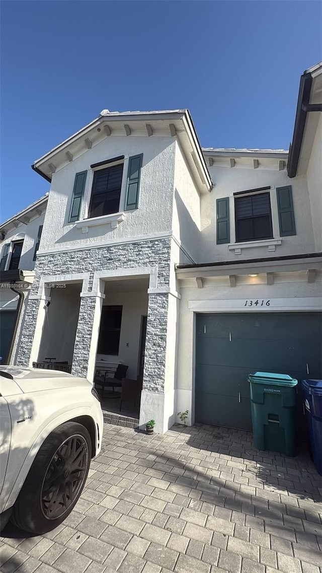 13416 SW 287th St Unit A, Homestead, FL 33033 - view of front of house with stucco siding, stone siding, and a garage
