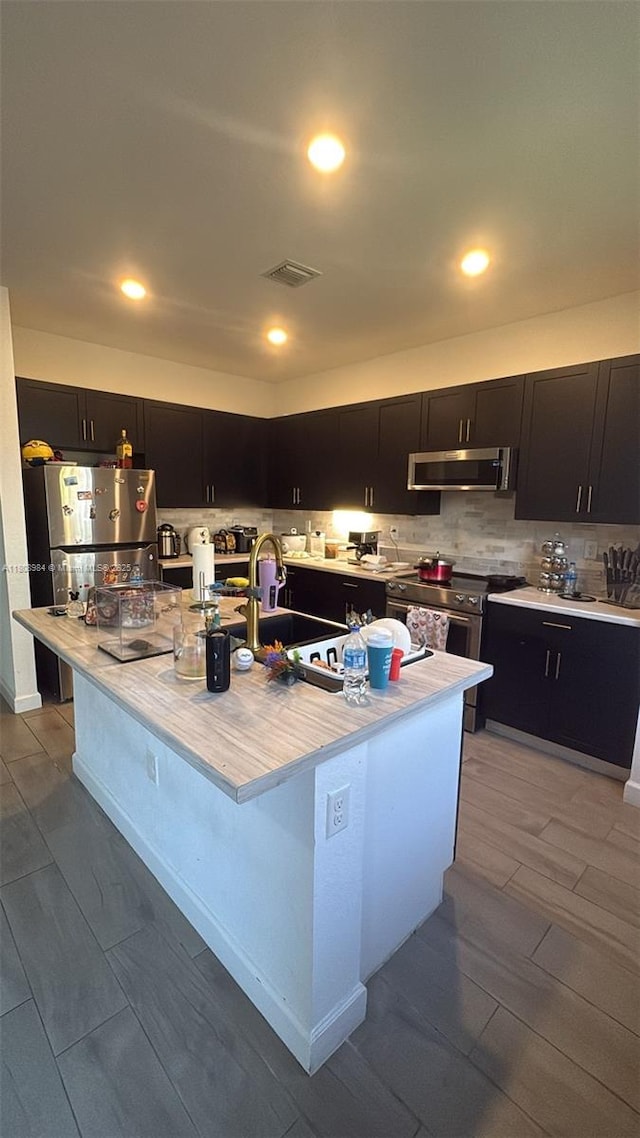 13416 SW 287th St Unit A, Homestead, FL 33033 - kitchen with stainless steel range with electric stovetop, extractor fan, dark cabinets, light countertops, and a sink