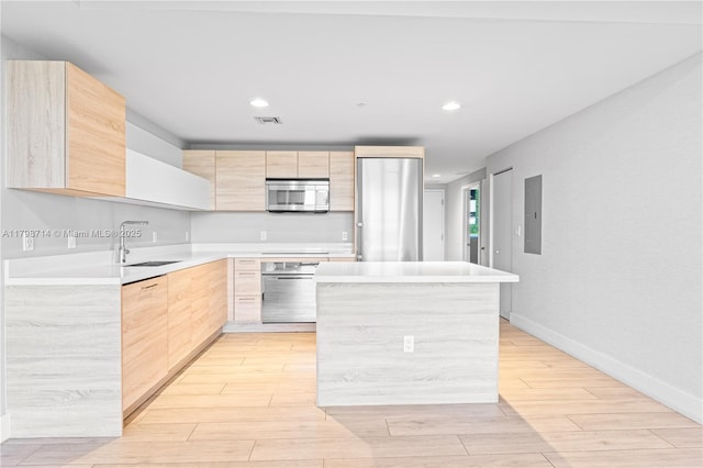 16385 Biscayne Blvd Unit 404, North Miami Beach, FL 33160 - kitchen featuring light brown cabinets, stainless steel appliances, modern cabinets, a sink, and light wood-type flooring
