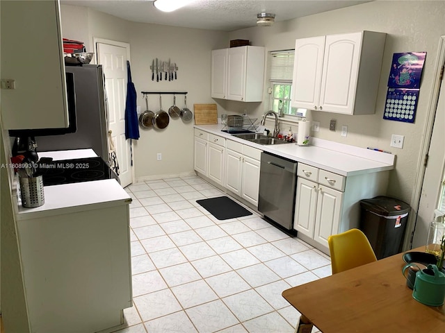 325 E Plymouth, Deland, FL 32724 - kitchen with stainless steel appliances, a sink, white cabinets, light countertops, and light tile patterned floors