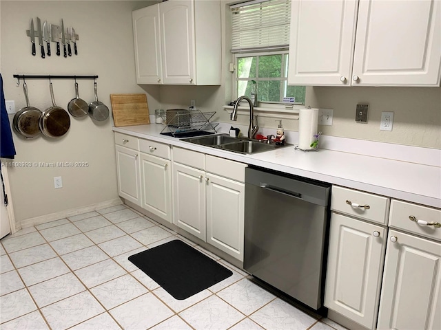 325 E Plymouth, Deland, FL 32724 - kitchen featuring stainless steel dishwasher, a sink, light countertops, and white cabinets