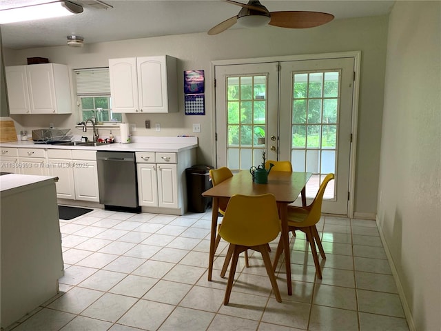 325 E Plymouth, Deland, FL 32724 - kitchen featuring stainless steel dishwasher, a sink, light tile patterned floors, light countertops, and white cabinetry