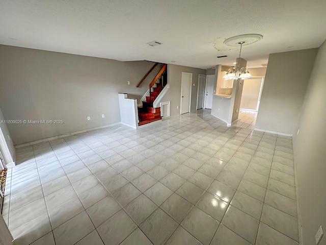 12873 SW 65th Ter, Miami, FL 33183 - unfurnished living room with stairway, a chandelier, baseboards, and light tile patterned floors