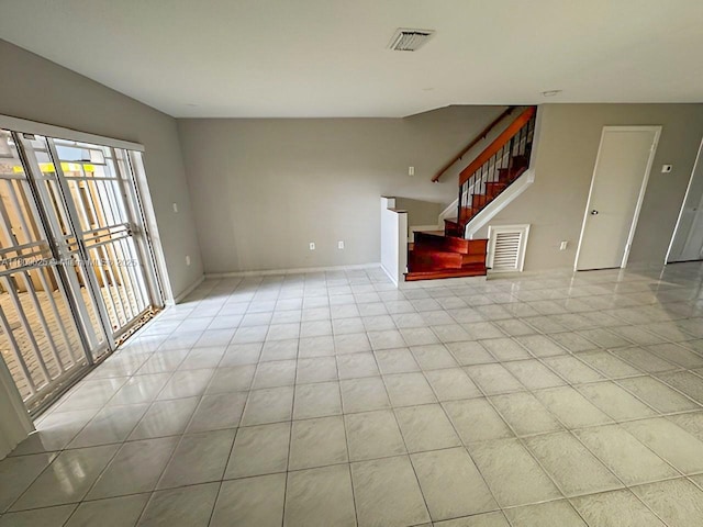 12873 SW 65th Ter, Miami, FL 33183 - unfurnished living room featuring stairs, light tile patterned floors, and baseboards