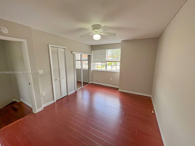 12873 SW 65th Ter, Miami, FL 33183 - unfurnished bedroom featuring baseboards, wood finished floors, multiple closets, and ceiling fan
