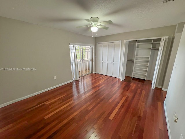12873 SW 65th Ter, Miami, FL 33183 - unfurnished bedroom featuring dark wood-type flooring, baseboards, multiple closets, and ceiling fan