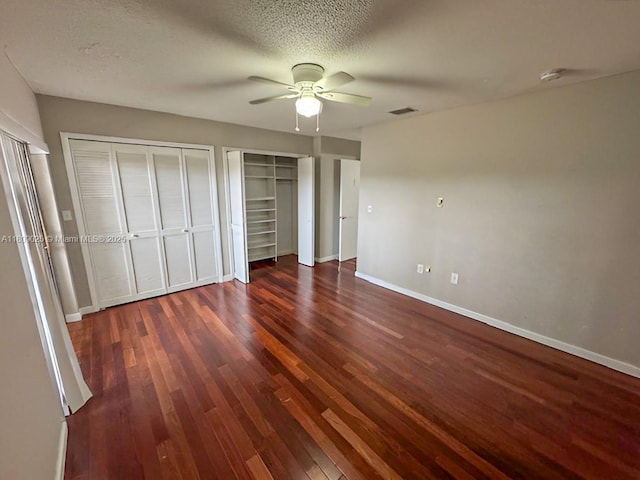 12873 SW 65th Ter, Miami, FL 33183 - unfurnished bedroom featuring wood finished floors, multiple closets, baseboards, and ceiling fan