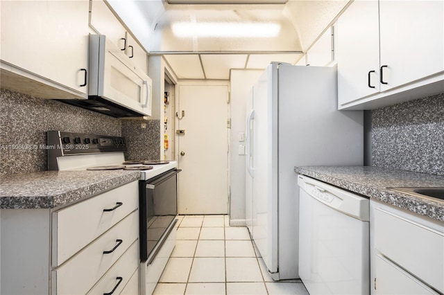6821 SW 147th Ave Unit 1F, Miami, FL 33193 - kitchen with white appliances, decorative backsplash, white cabinetry, and light tile patterned floors