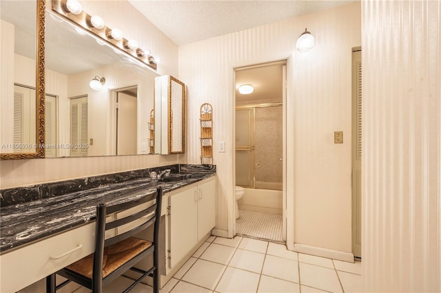 6821 SW 147th Ave Unit 1F, Miami, FL 33193 - bathroom featuring vanity, toilet, enclosed tub / shower combo, tile patterned floors, and baseboards