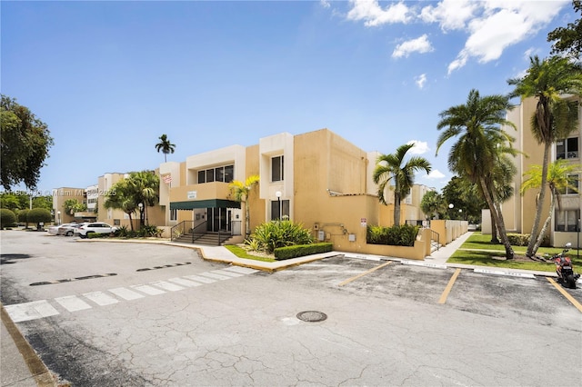 6821 SW 147th Ave Unit 1F, Miami, FL 33193 - view of building exterior with uncovered parking and a residential view