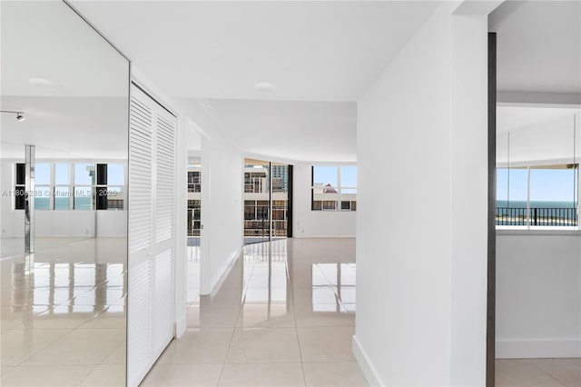 1901 Brickell Ave Unit B1903, Miami, FL 33129 - hallway with healthy amount of natural light, baseboards, and tile patterned floors