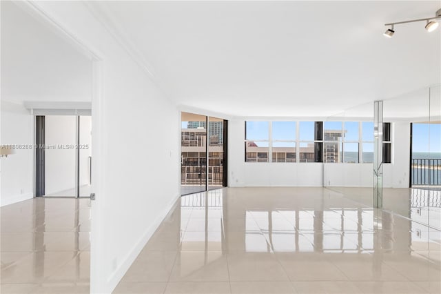 1901 Brickell Ave Unit B1903, Miami, FL 33129 - tiled spare room with ornamental molding, baseboards, and a wall of windows