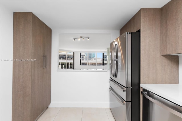 1901 Brickell Ave Unit B1903, Miami, FL 33129 - kitchen with appliances with stainless steel finishes, light countertops, light tile patterned floors, and baseboards