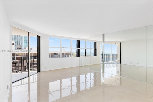 1901 Brickell Ave Unit B1903, Miami, FL 33129 - spare room featuring expansive windows, plenty of natural light, and tile patterned flooring