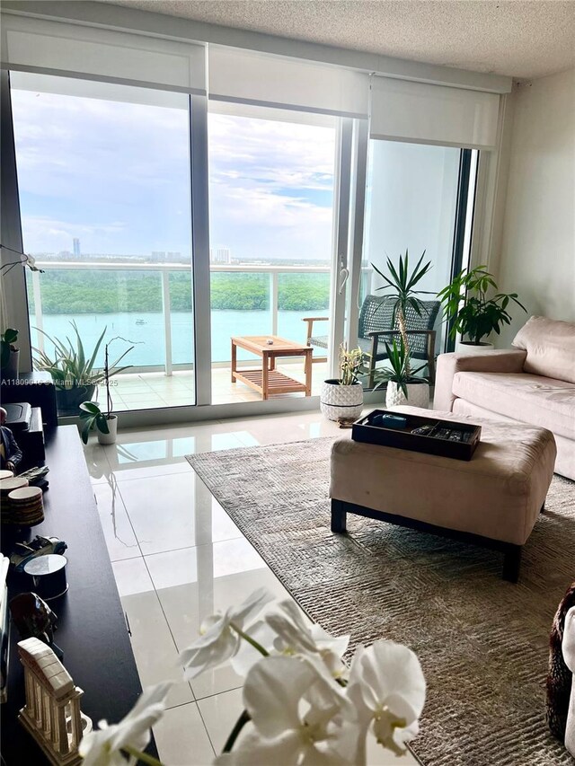 100 Bayview Dr Unit 1919, Sunny Isles Beach, FL 33160 - living area with floor to ceiling windows, healthy amount of natural light, a textured ceiling, and a water view