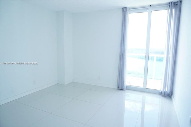 100 Bayview Dr Unit 1919, Sunny Isles Beach, FL 33160 - tiled empty room with baseboards