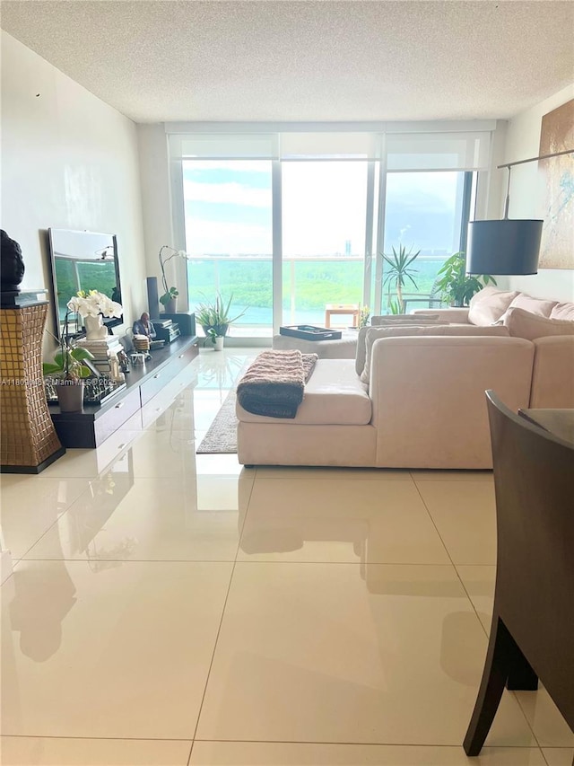 100 Bayview Dr Unit 1919, Sunny Isles Beach, FL 33160 - tiled living area with a textured ceiling and expansive windows