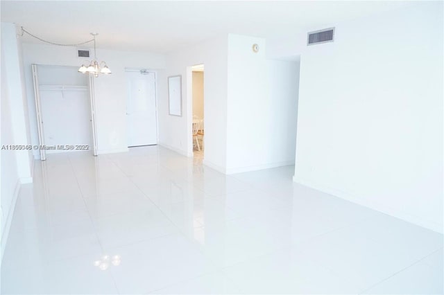 100 Bayview Dr Unit 1919, Sunny Isles Beach, FL 33160 - empty room with a chandelier, baseboards, and light tile patterned floors