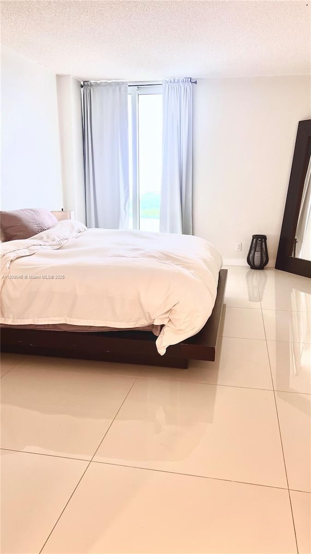 100 Bayview Dr Unit 1919, Sunny Isles Beach, FL 33160 - tiled bedroom featuring a textured ceiling