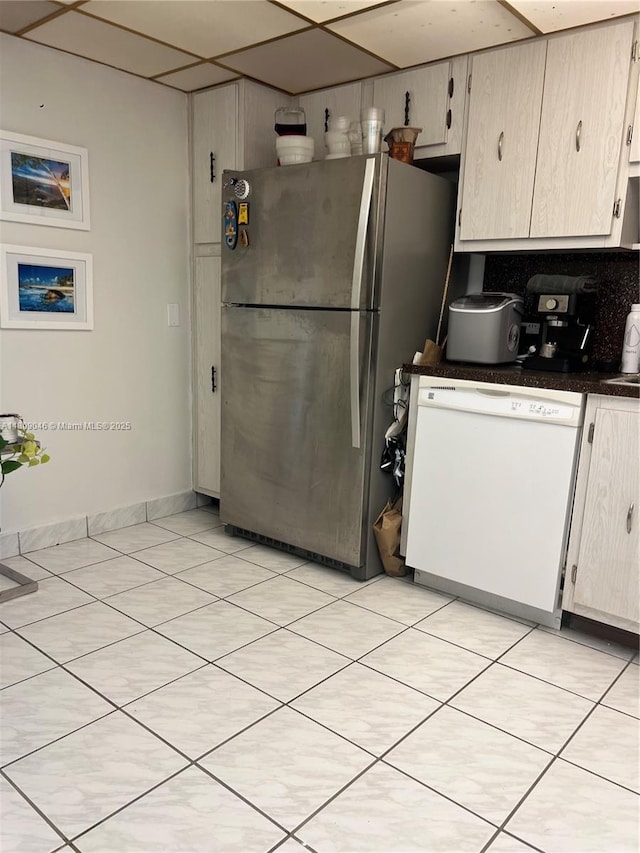 100 Bayview Dr Unit 1919, Sunny Isles Beach, FL 33160 - kitchen with white dishwasher, freestanding refrigerator, dark countertops, and light tile patterned flooring
