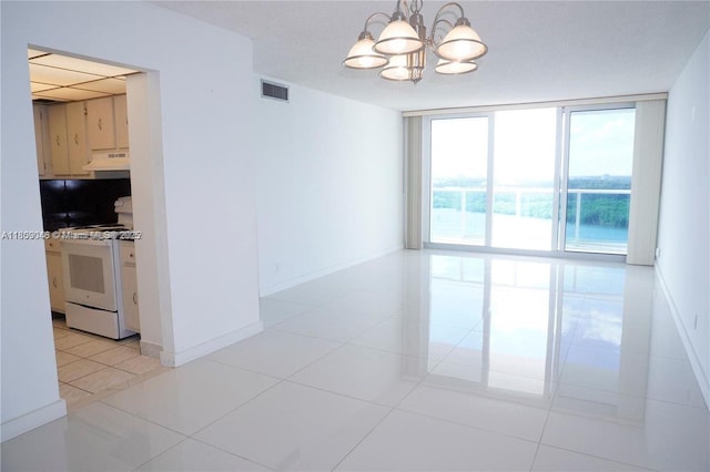 100 Bayview Dr Unit 1919, Sunny Isles Beach, FL 33160 - empty room with a chandelier, a wall of windows, and light tile patterned floors