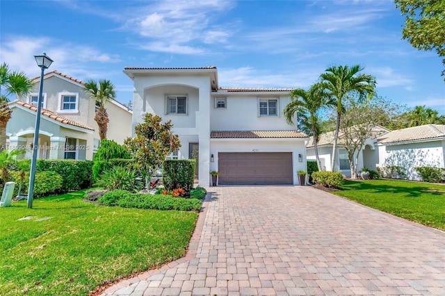 4231 N Magnolia Cir, Delray Beach, FL 33445 - mediterranean / spanish home with a tile roof, decorative driveway, stucco siding, an attached garage, and a front yard
