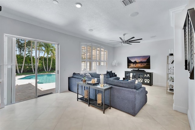 4231 N Magnolia Cir, Delray Beach, FL 33445 - living room with crown molding, ceiling fan, a textured ceiling, light tile patterned flooring, and baseboards