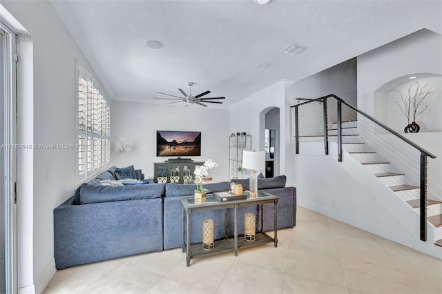 4231 N Magnolia Cir, Delray Beach, FL 33445 - tiled living area featuring arched walkways, stairway, a ceiling fan, and crown molding