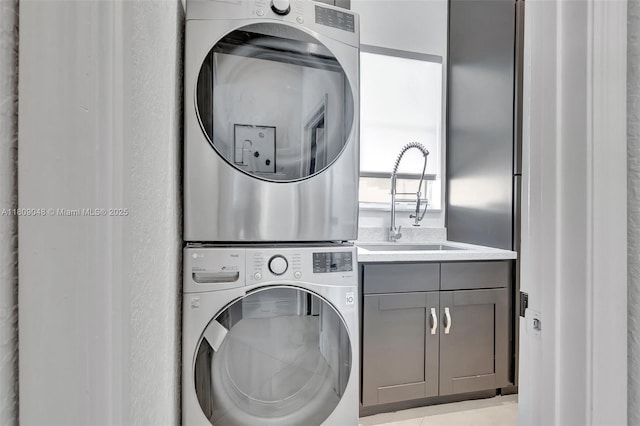 4231 N Magnolia Cir, Delray Beach, FL 33445 - laundry room featuring estacked washer and dryer and cabinet space