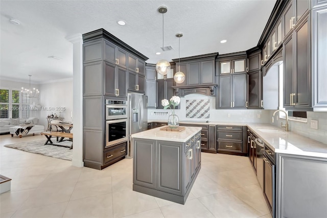 4231 N Magnolia Cir, Delray Beach, FL 33445 - kitchen with a sink, backsplash, ornamental molding, a chandelier, and glass insert cabinets