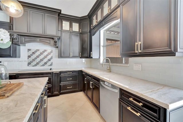 4231 N Magnolia Cir, Delray Beach, FL 33445 - kitchen featuring stainless steel dishwasher, a sink, backsplash, and light stone countertops
