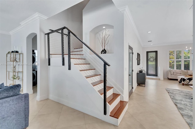 4231 N Magnolia Cir, Delray Beach, FL 33445 - stairway featuring ornamental molding, tile patterned flooring, baseboards, arched walkways, and recessed lighting