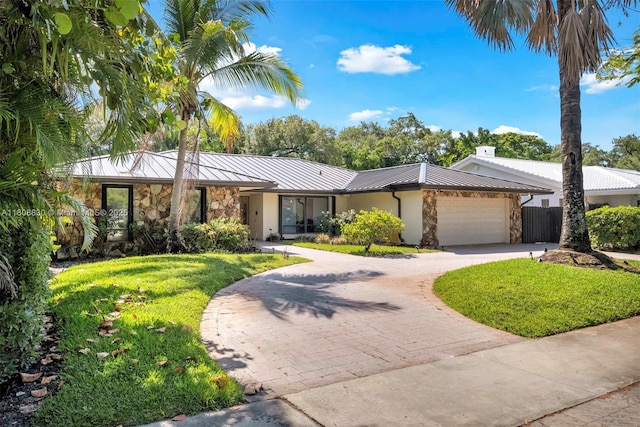 3721 N Park Rd, Hollywood, FL 33021 - mid-century modern home with stone siding, a standing seam roof, and curved driveway