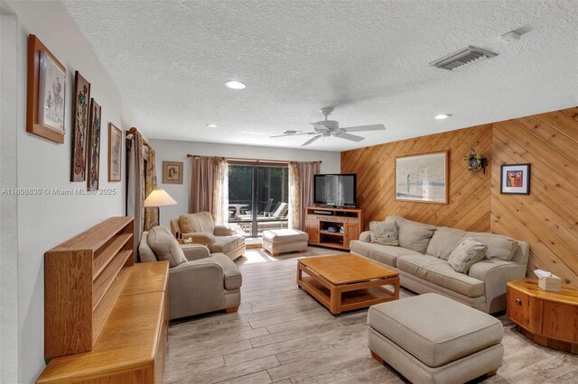 3721 N Park Rd, Hollywood, FL 33021 - living area with light wood-style flooring, ceiling fan, a textured ceiling, wooden walls, and recessed lighting
