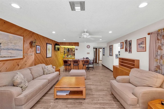3721 N Park Rd, Hollywood, FL 33021 - living room with ceiling fan, recessed lighting, wood walls, light wood-style floors, and a textured ceiling