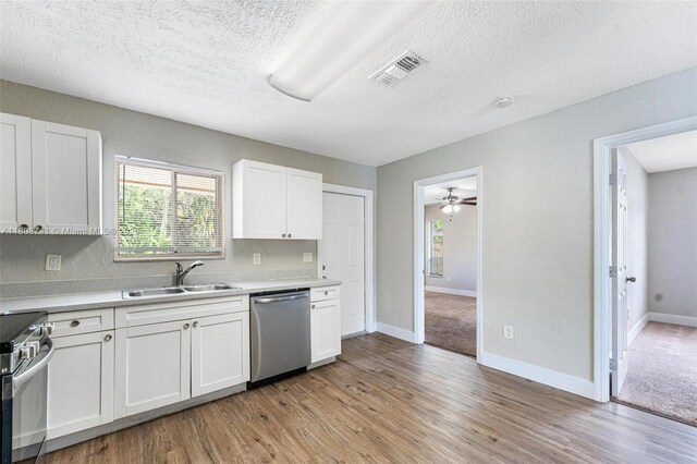 22123 SW 62nd Ct, Boca Raton, FL 33428 - kitchen with appliances with stainless steel finishes, a sink, light wood-type flooring, light countertops, and a textured ceiling