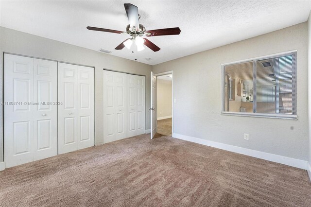 22123 SW 62nd Ct, Boca Raton, FL 33428 - unfurnished bedroom featuring multiple closets, carpet, baseboards, a ceiling fan, and a textured ceiling