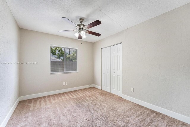22123 SW 62nd Ct, Boca Raton, FL 33428 - unfurnished bedroom featuring carpet, a closet, a textured ceiling, baseboards, and a textured wall