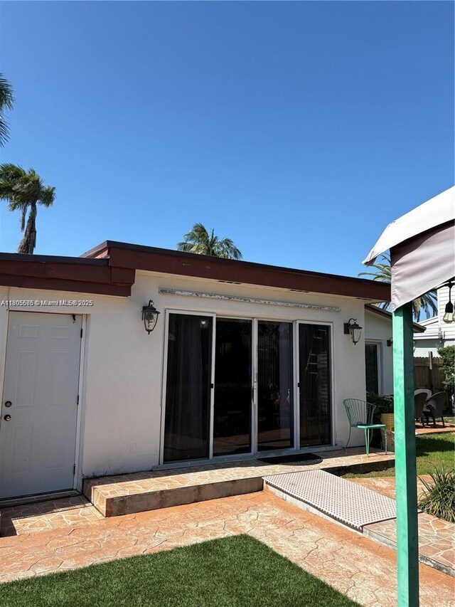 7430 Buchanan St, Hollywood, FL 33024 - rear view of house featuring stucco siding and a patio