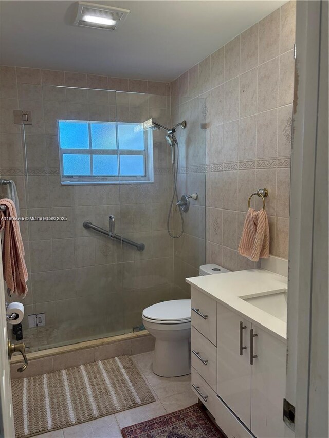 7430 Buchanan St, Hollywood, FL 33024 - full bath featuring a stall shower, tile patterned flooring, vanity, and tile walls