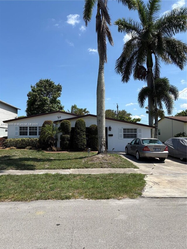 7430 Buchanan St, Hollywood, FL 33024 - view of front of property with a front lawn and concrete driveway