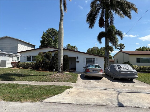 7430 Buchanan St, Hollywood, FL 33024 - view of front of home with concrete driveway and a front lawn